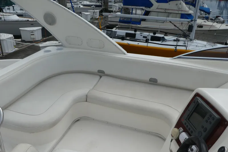Slide: The Image of 2003 Meridian 341 Sedan yacht interior with white seating and control panel at marina. - 28