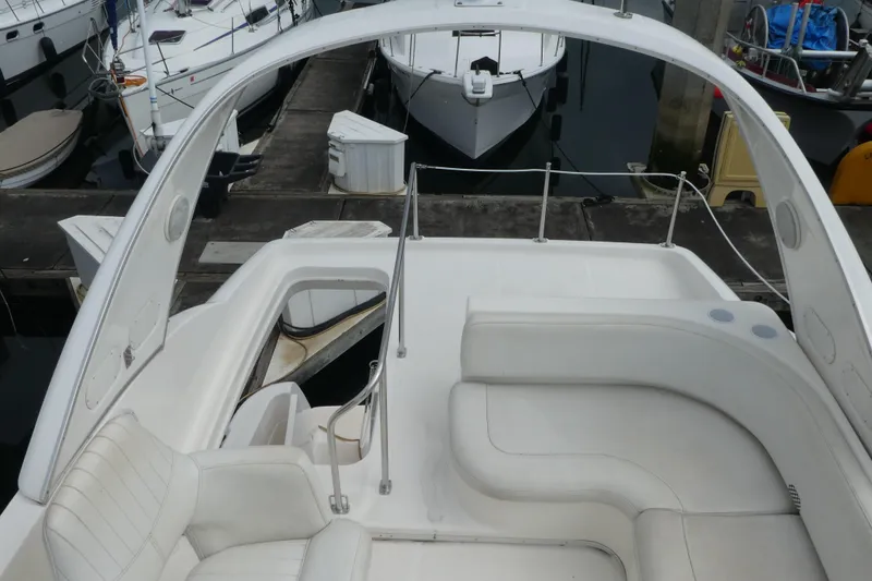 Slide: The Image of 2003 Meridian 341 Sedan yacht interior with white seating at marina dock. - 29