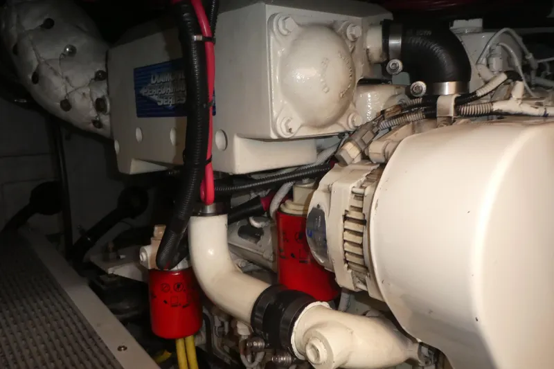 Slide: The Image of Engine compartment of a 2003 Meridian 341 Sedan boat, showcasing mechanical components and wiring. - 32