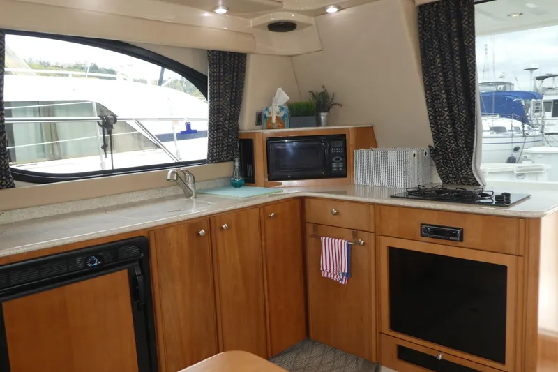 Slide: The Image of Interior of 2003 Meridian 341 Sedan yacht kitchen with appliances and window view. - 5