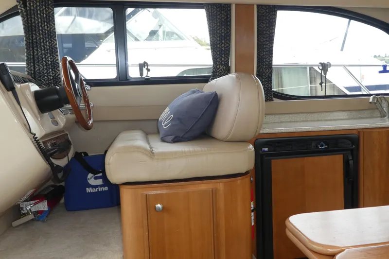 Slide: The Image of Interior of 2003 Meridian 341 Sedan yacht with helm, seating, and mini fridge. - 6