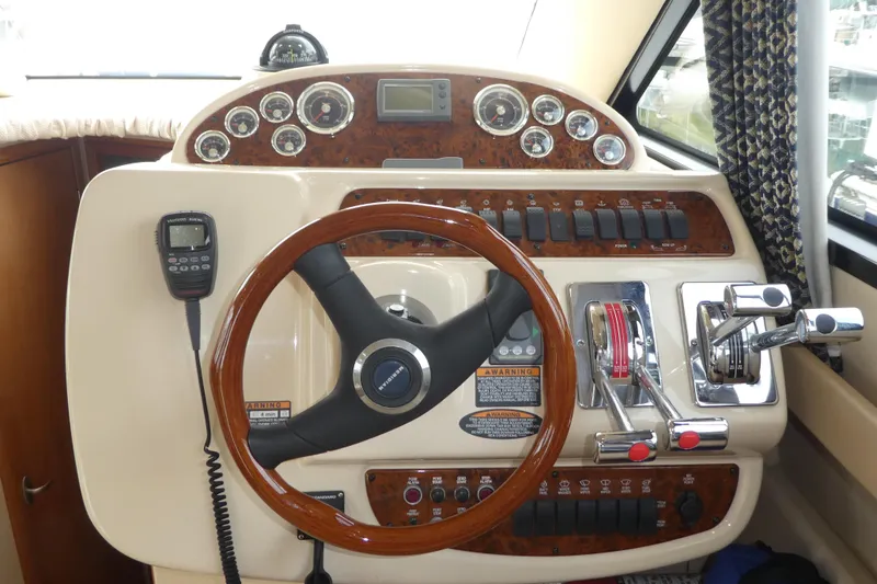 Slide: The Image of 2003 Meridian 341 Sedan helm with wood accents, steering wheel, and control panel. - 7