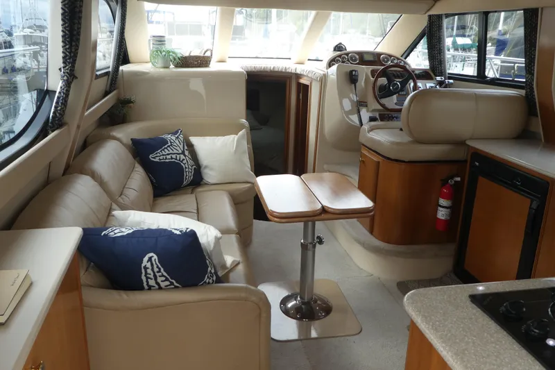 Slide: The Image of Interior of a 2003 Meridian 341 Sedan yacht with beige seating and wooden accents. - 9