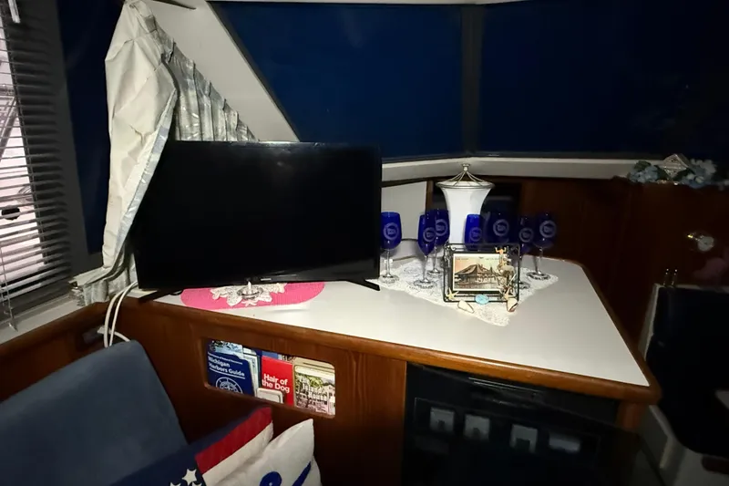 Slide: The Image of Interior of 1994 Carver 390 Cockpit Motor Yacht with TV and decorative items. - 10
