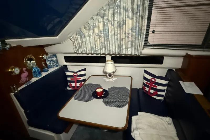 Slide: The Image of Cozy interior of 1994 Carver 390 Cockpit Motor Yacht with nautical-themed decor. - 11