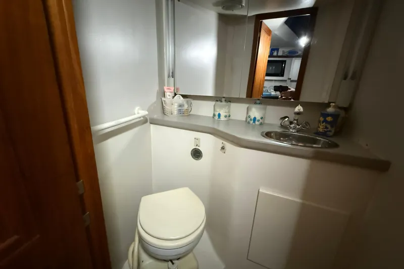 Slide: The Image of Bathroom interior of 1994 Carver 390 Cockpit Motor Yacht, featuring sink and toilet. - 13