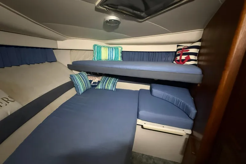 Slide: The Image of Cozy cabin interior of 1994 Carver 390 Cockpit Motor Yacht with blue bedding and nautical decor. - 15