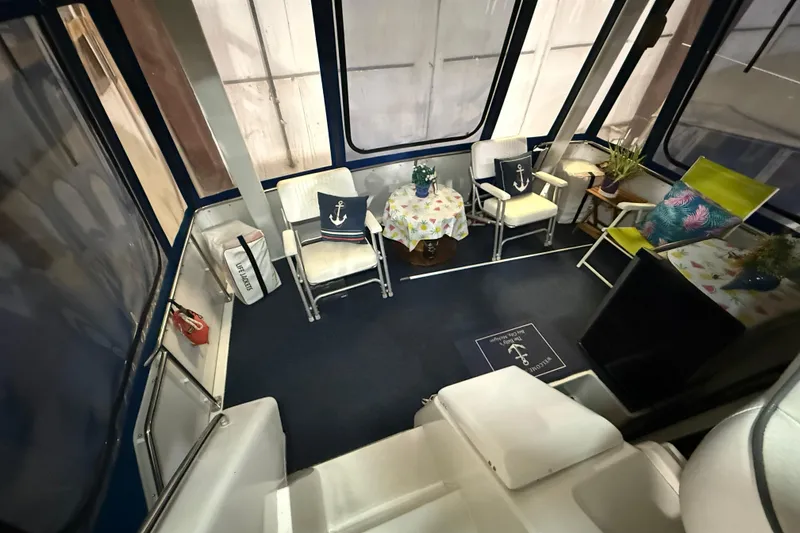 Slide: The Image of Interior of 1994 Carver 390 Cockpit Motor Yacht with cozy seating and nautical decor. - 18