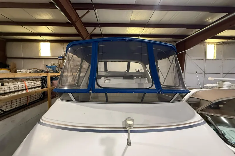 Slide: The Image of 1994 Carver 390 Cockpit Motor Yacht in storage, featuring blue canopy and spacious cockpit. - 23