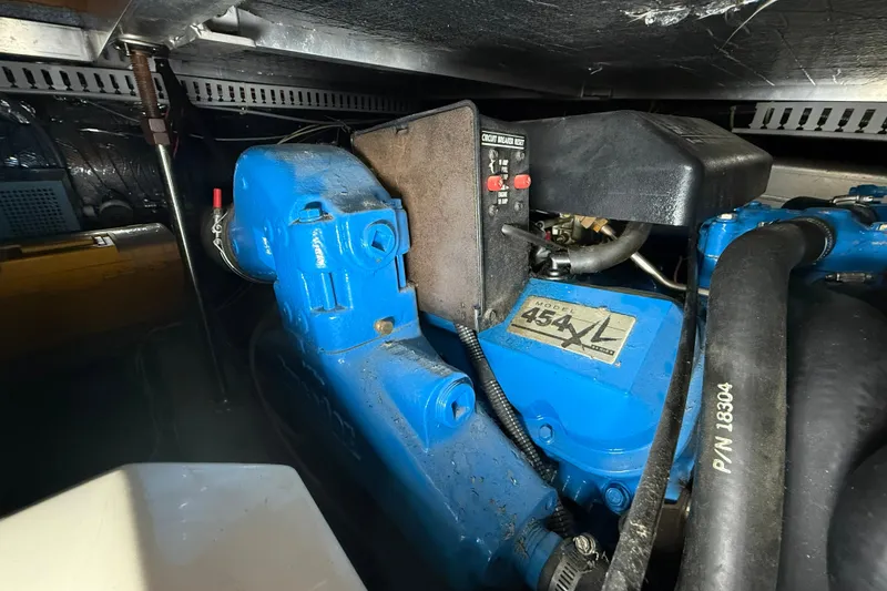 Slide: The Image of Engine compartment of a 1994 Carver 390 Cockpit Motor Yacht, featuring a blue 454 XL engine. - 24