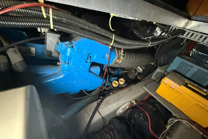 Slide: The Image of Engine compartment of a 1994 Carver 390 Cockpit Motor Yacht, featuring blue components and wiring. - 25