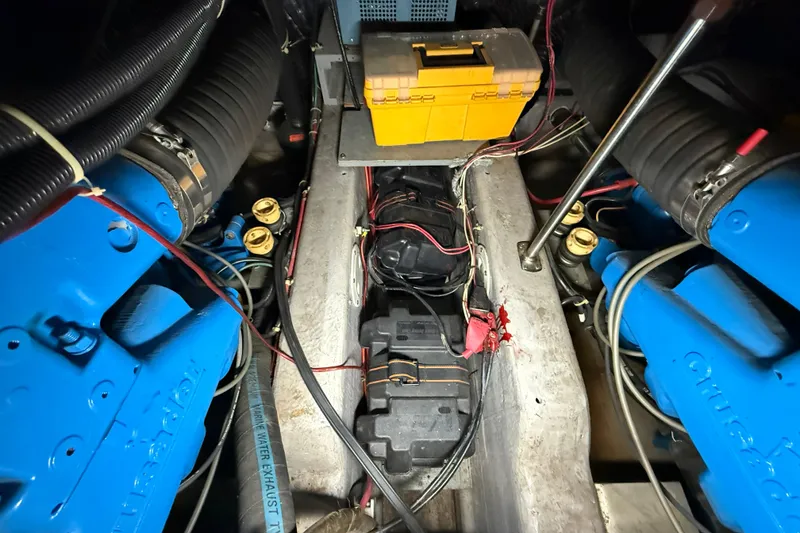 Slide: The Image of Engine compartment of a 1994 Carver 390 Cockpit Motor Yacht with visible wiring and components. - 26