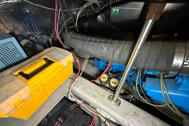Slide: The Image of Engine compartment of 1994 Carver 390 Cockpit Motor Yacht with tools and wiring. - 27
