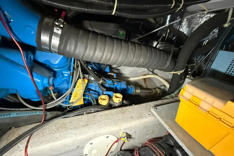 Slide: The Image of Engine compartment of a 1994 Carver 390 Cockpit Motor Yacht with visible hoses and wiring. - 28