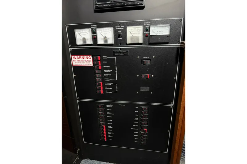 Slide: The Image of Electrical panel of a 1994 Carver 390 Cockpit Motor Yacht with gauges and switches. - 29