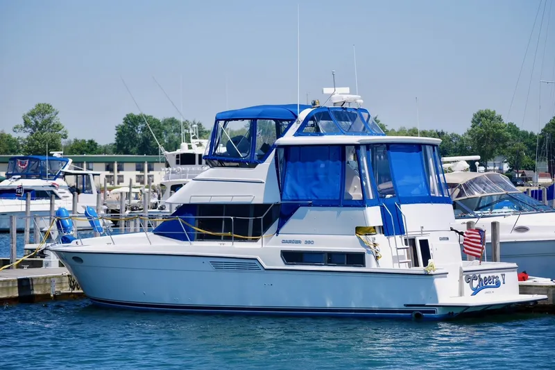 Slide: The Image of 1994 Carver 390 Cockpit Motor Yacht docked at marina with blue canopy. - 31