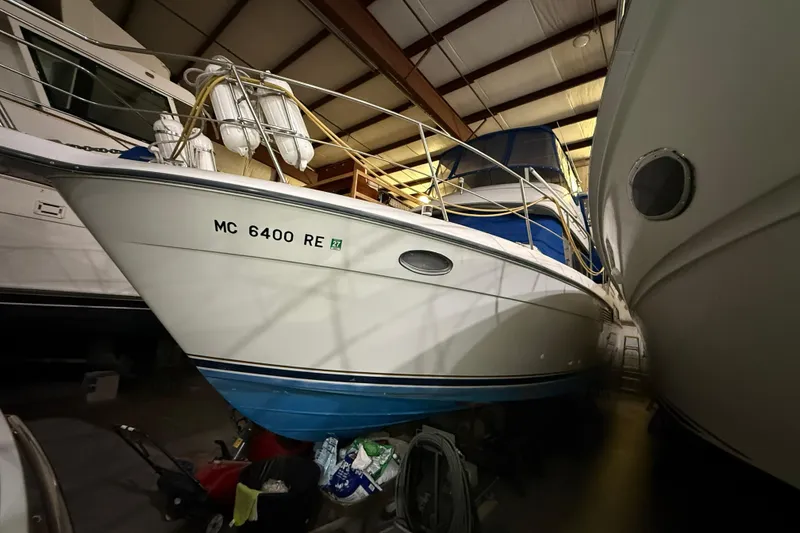 Slide: The Image of 1994 Carver 390 Cockpit Motor Yacht in storage, showcasing sleek design and blue hull. - 32