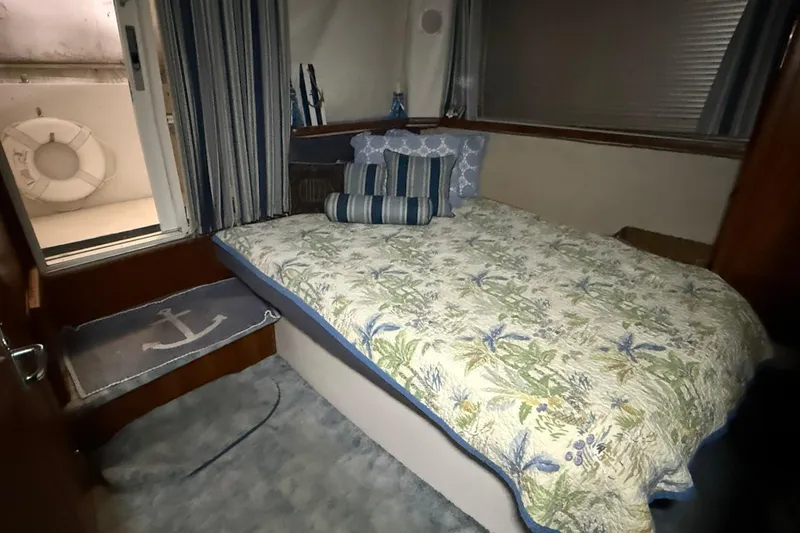 Slide: The Image of Cozy bedroom in 1994 Carver 390 Cockpit Motor Yacht with floral bedding and nautical decor. - 4