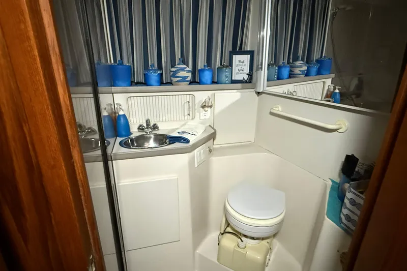 Slide: The Image of Bathroom interior of 1994 Carver 390 Cockpit Motor Yacht with nautical decor. - 6