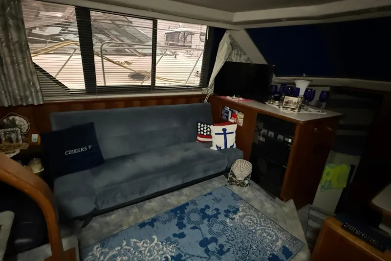Slide: The Image of Interior of 1994 Carver 390 Cockpit Motor Yacht with cozy seating and nautical decor. - 8