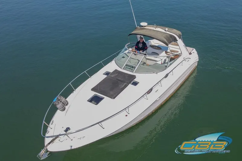 The Image of 2000 Sea Ray 340 Sundancer boat on calm water, aerial view. - 0