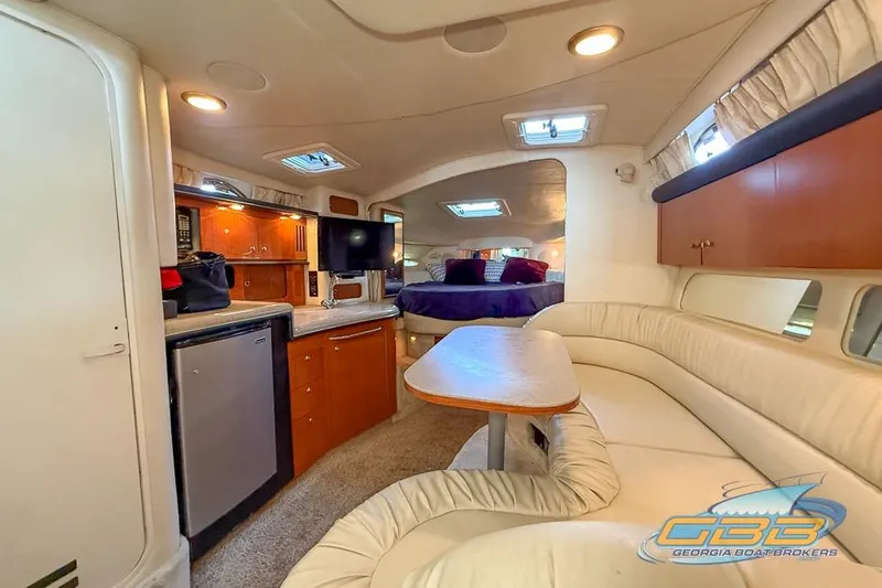Slide: The Image of Interior of 2000 Sea Ray 340 Sundancer yacht with cozy seating and kitchenette. - 11