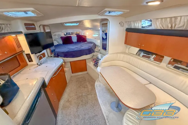 Slide: The Image of Interior of 2000 Sea Ray 340 Sundancer yacht with cozy seating and modern amenities. - 13