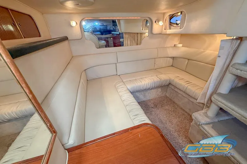 Slide: The Image of Interior of 2000 Sea Ray 340 Sundancer yacht with beige seating and cozy ambiance. - 14