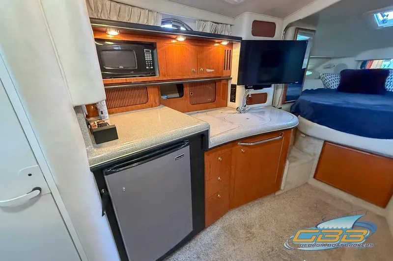 Slide: The Image of Interior of 2000 Sea Ray 340 Sundancer with kitchenette and sleeping area. - 15