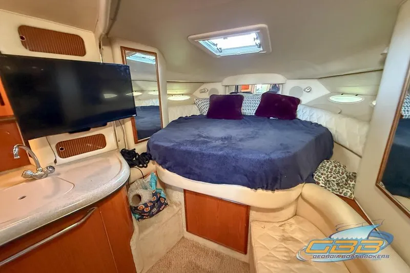 Slide: The Image of Interior of 2000 Sea Ray 340 Sundancer with cozy bed, TV, and sink. - 18