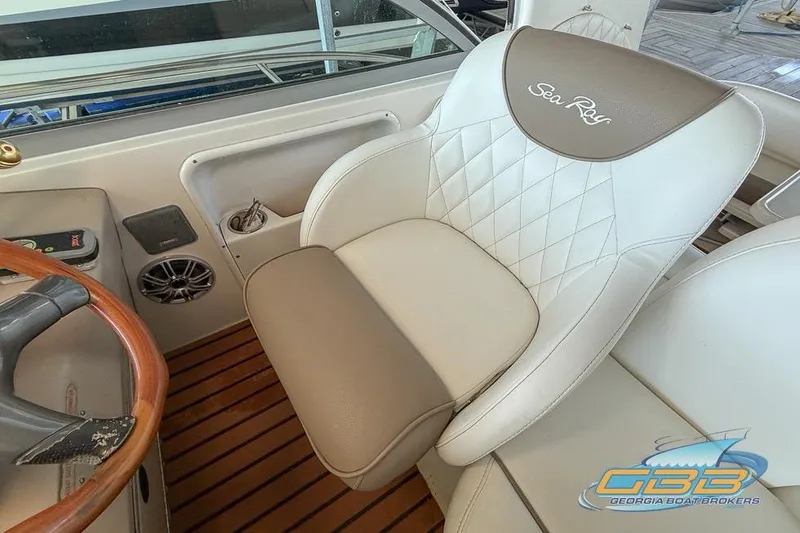 Slide: The Image of Captain's seat on 2000 Sea Ray 340 Sundancer boat with wood accents and logo. - 19