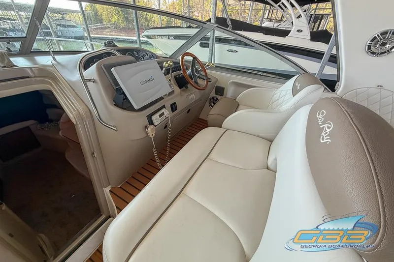 Slide: The Image of Interior of 2000 Sea Ray 340 Sundancer with Garmin navigation system and plush seating. - 2