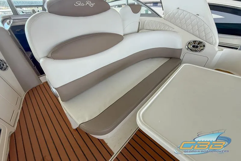 Slide: The Image of Interior of 2000 Sea Ray 340 Sundancer with cushioned seating and wooden flooring. - 23