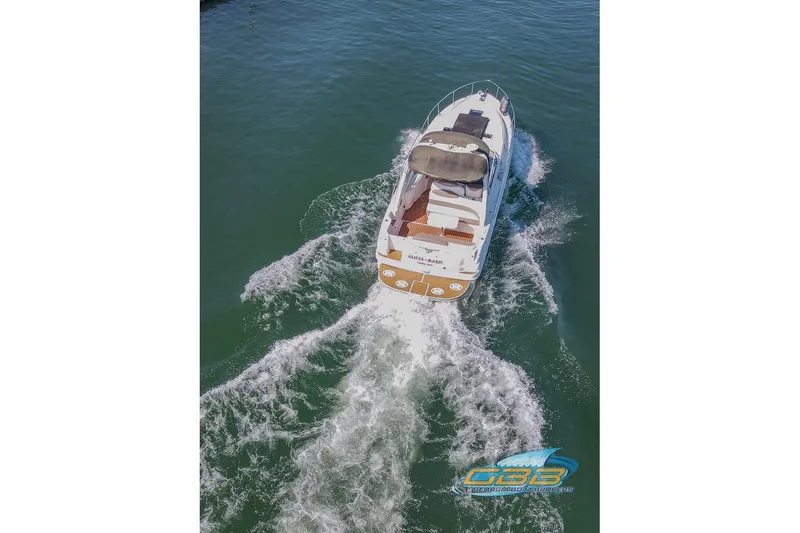 Slide: The Image of Aerial view of 2000 Sea Ray 340 Sundancer cruising on open water. - 27