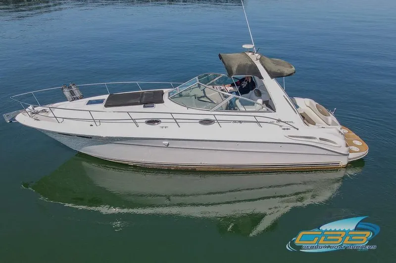 Slide: The Image of 2000 Sea Ray 340 Sundancer yacht on calm water, side view. - 28