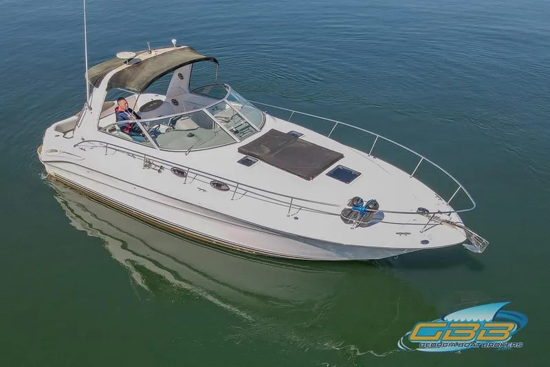 Slide: The Image of 2000 Sea Ray 340 Sundancer boat on calm water, aerial view. - 29