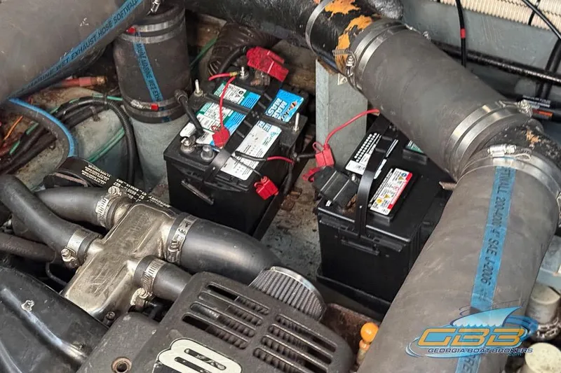 Slide: The Image of Engine compartment of a 2000 Sea Ray 340 Sundancer with visible batteries and hoses. - 44