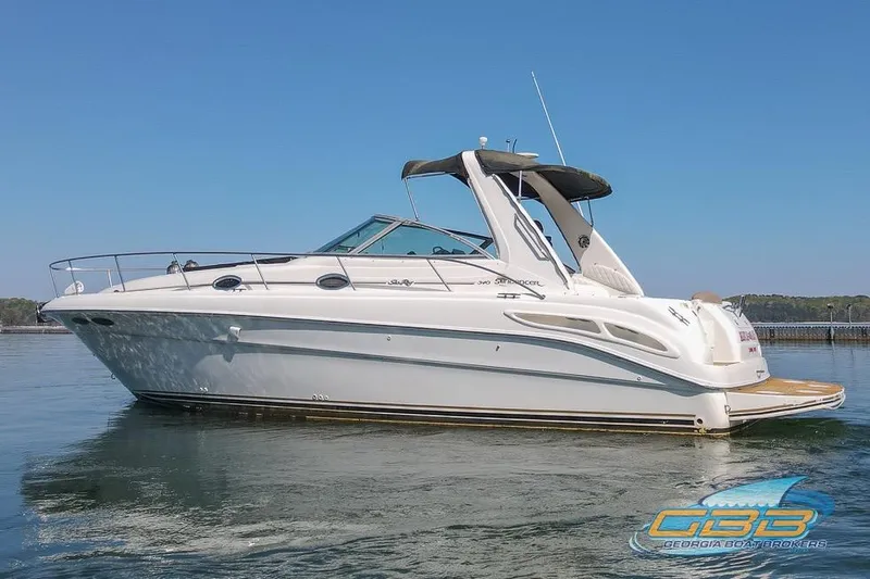 Slide: The Image of 2000 Sea Ray 340 Sundancer boat on calm water, clear sky background. - 5