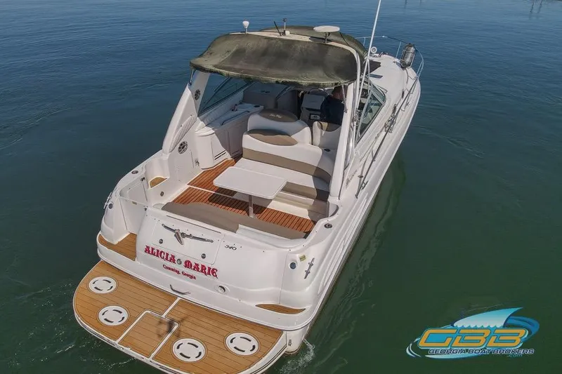 Slide: The Image of 2000 Sea Ray 340 Sundancer yacht on calm water, rear view with seating area. - 6