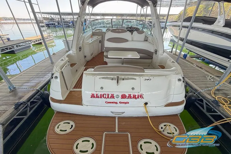 Slide: The Image of 2000 Sea Ray 340 Sundancer docked, featuring spacious seating and elegant design. - 8