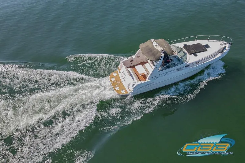 Slide: The Image of 2000 Sea Ray 340 Sundancer cruising on open water, aerial view. - 9