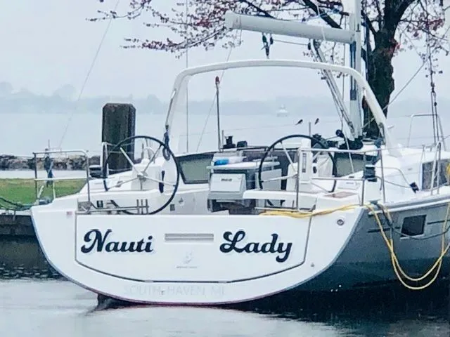 Slide: The Image of Beneteau Oceanis 41.1 sailboat, 2017, docked with "Nauti Lady" lettering. - 3