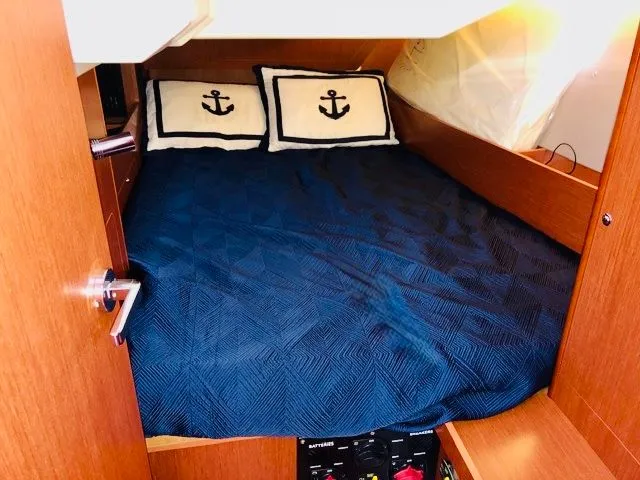 Slide: The Image of Beneteau Oceanis 41.1 cabin, 2017, with blue bedding and anchor-themed pillows. - 5