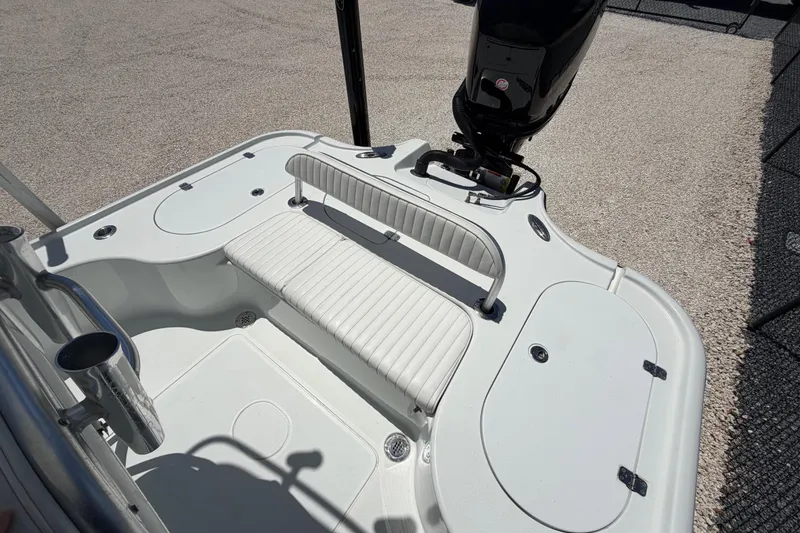 Slide: The Image of 2012 Yellowfin 24 Bay boat interior with seating and motor, showcasing sleek design. - 4