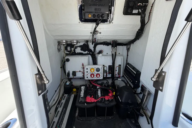 Slide: The Image of 2012 Yellowfin 24 Bay boat electrical compartment with batteries and wiring. - 6