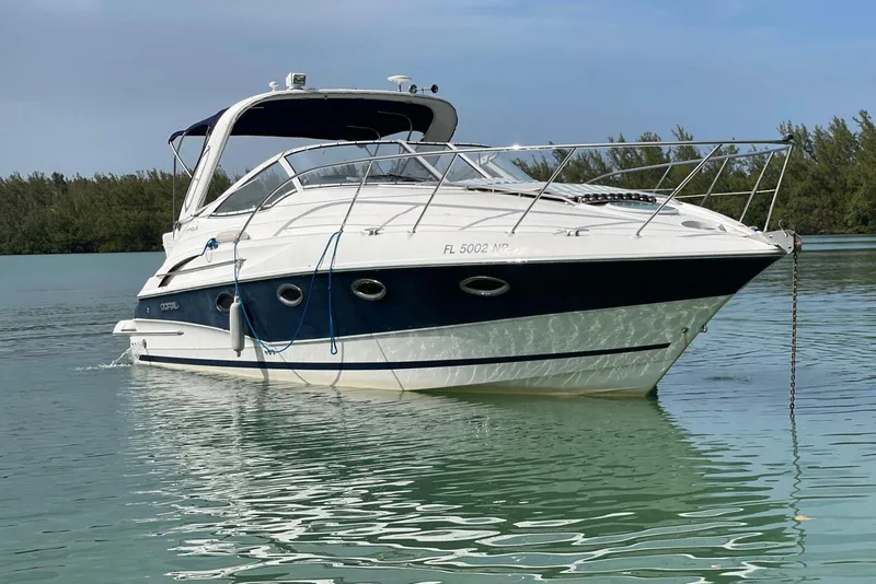 The Image of 2007 Doral Intrigue boat on calm water, surrounded by lush greenery. - 0
