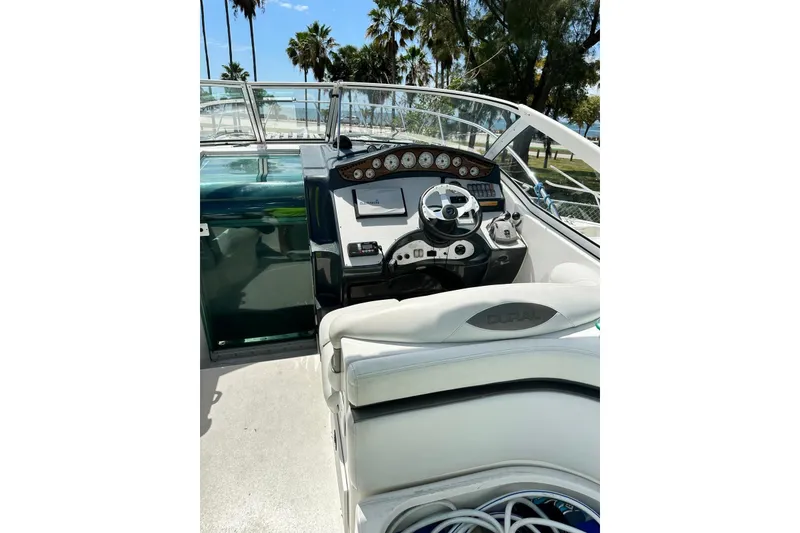 Slide: The Image of 2007 Doral Intrigue boat cockpit with steering wheel and control panel. - 11