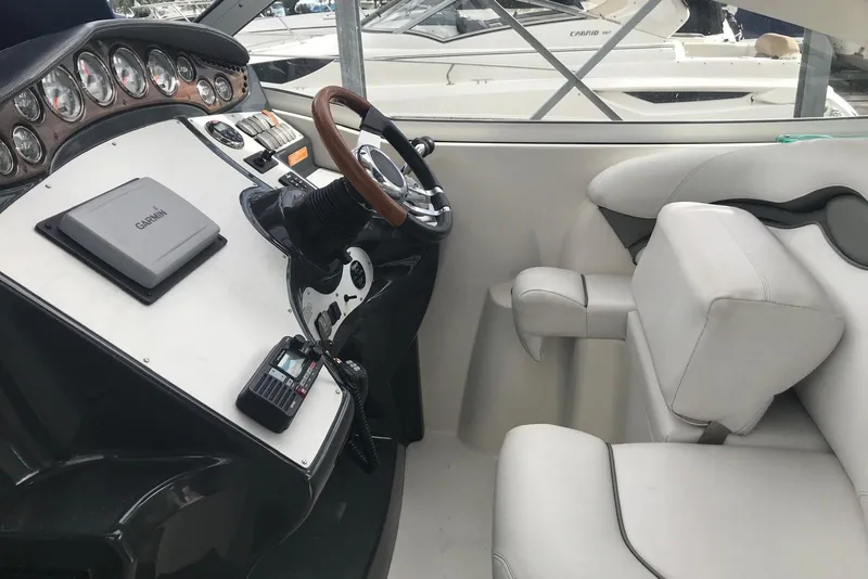 Slide: The Image of 2007 Doral Intrigue boat cockpit with Garmin navigation and white leather seating. - 12