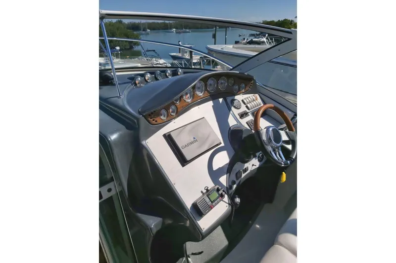 Slide: The Image of 2007 Doral Intrigue boat dashboard with steering wheel and navigation instruments. - 13