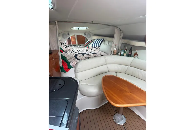 Slide: The Image of Interior of 2007 Doral Intrigue boat with cozy seating and wooden table. - 14